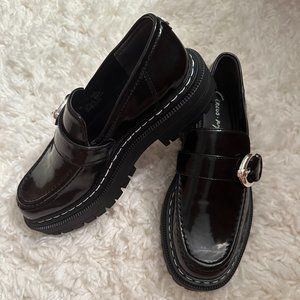 Black shiny patent leather loafers with buckle. Size 7.5